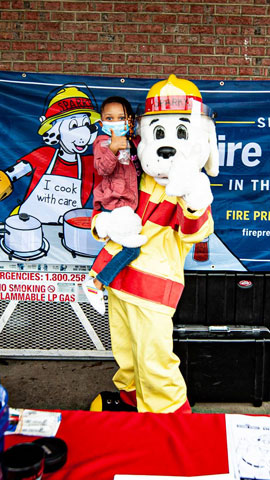Dog mascot holding child