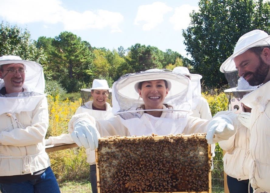Bee Downtown group picture with bee hive