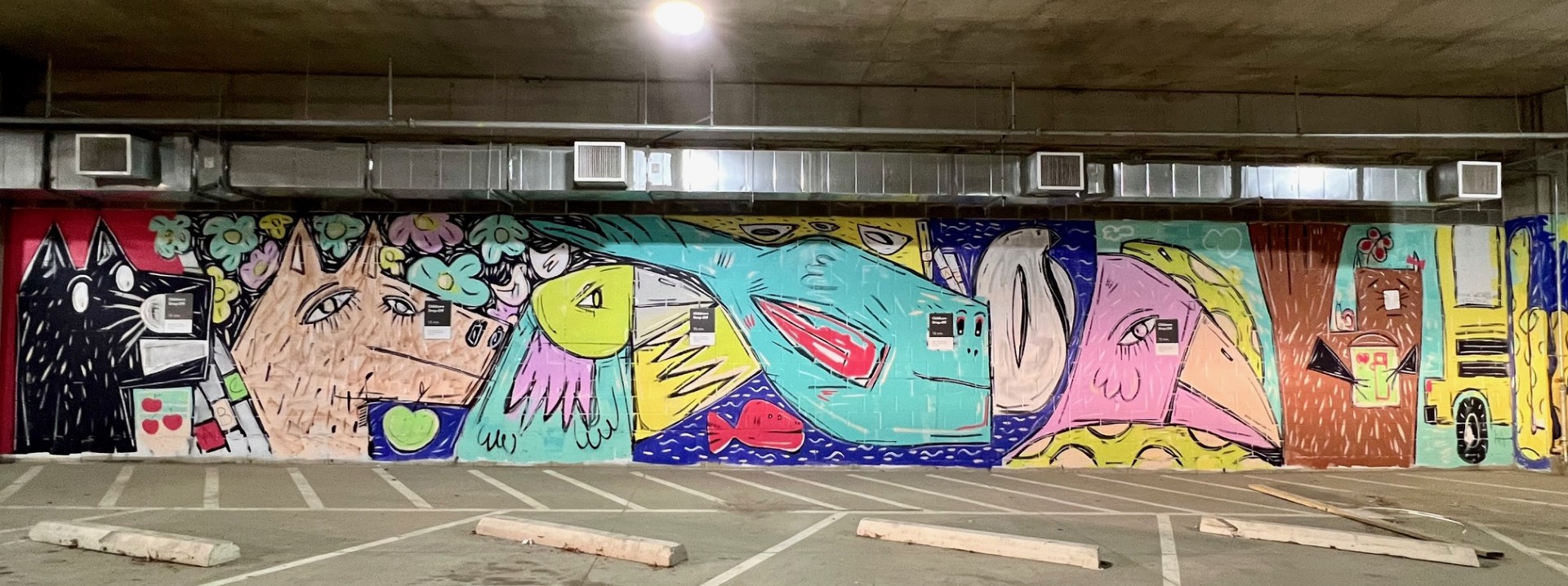 playful mural of animals getting ready to go to school in bright colors