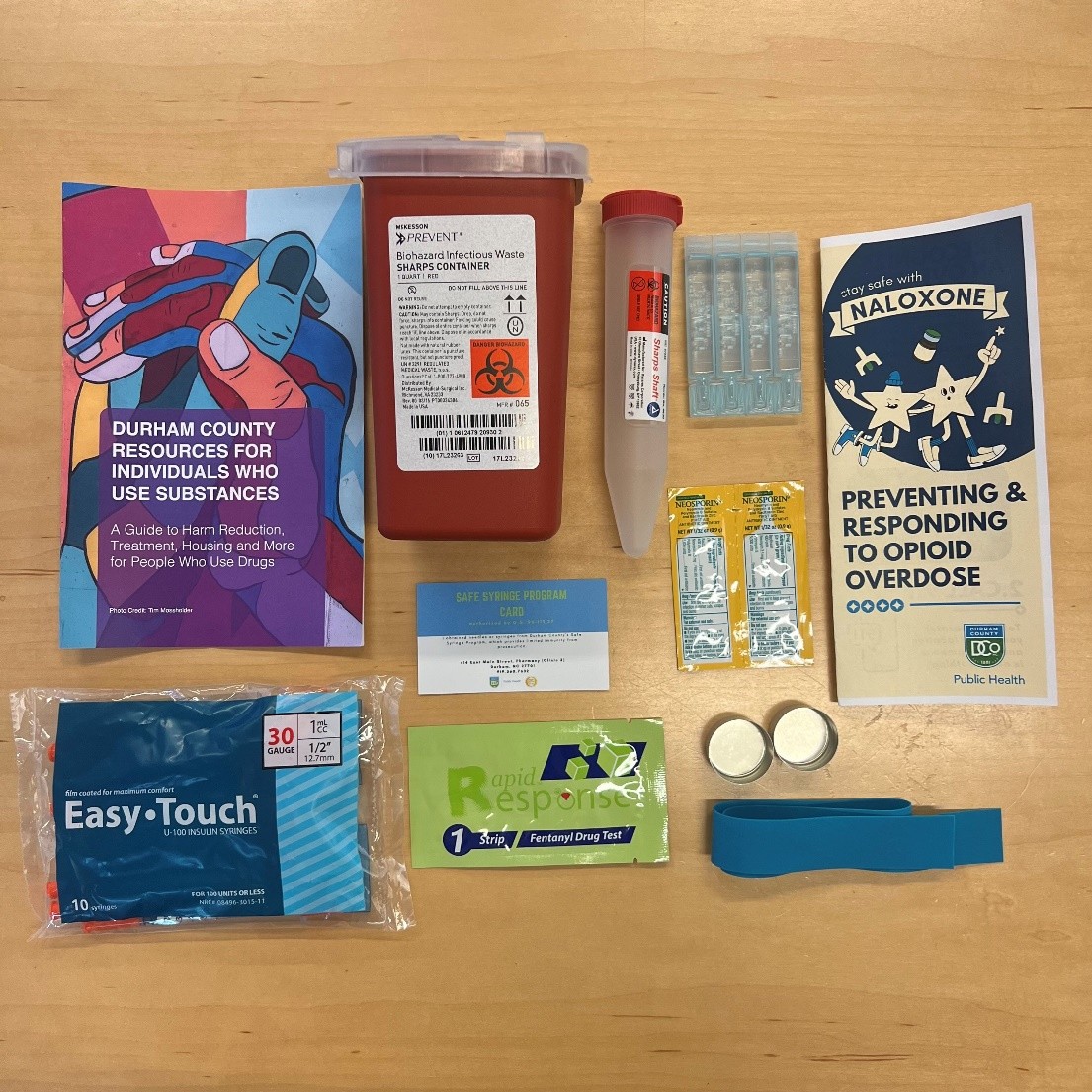 Materials for safe injections, including gloves and a sharp disposal box