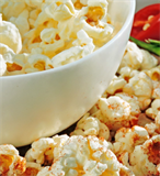 A bowl of popcorn sitting on a table.