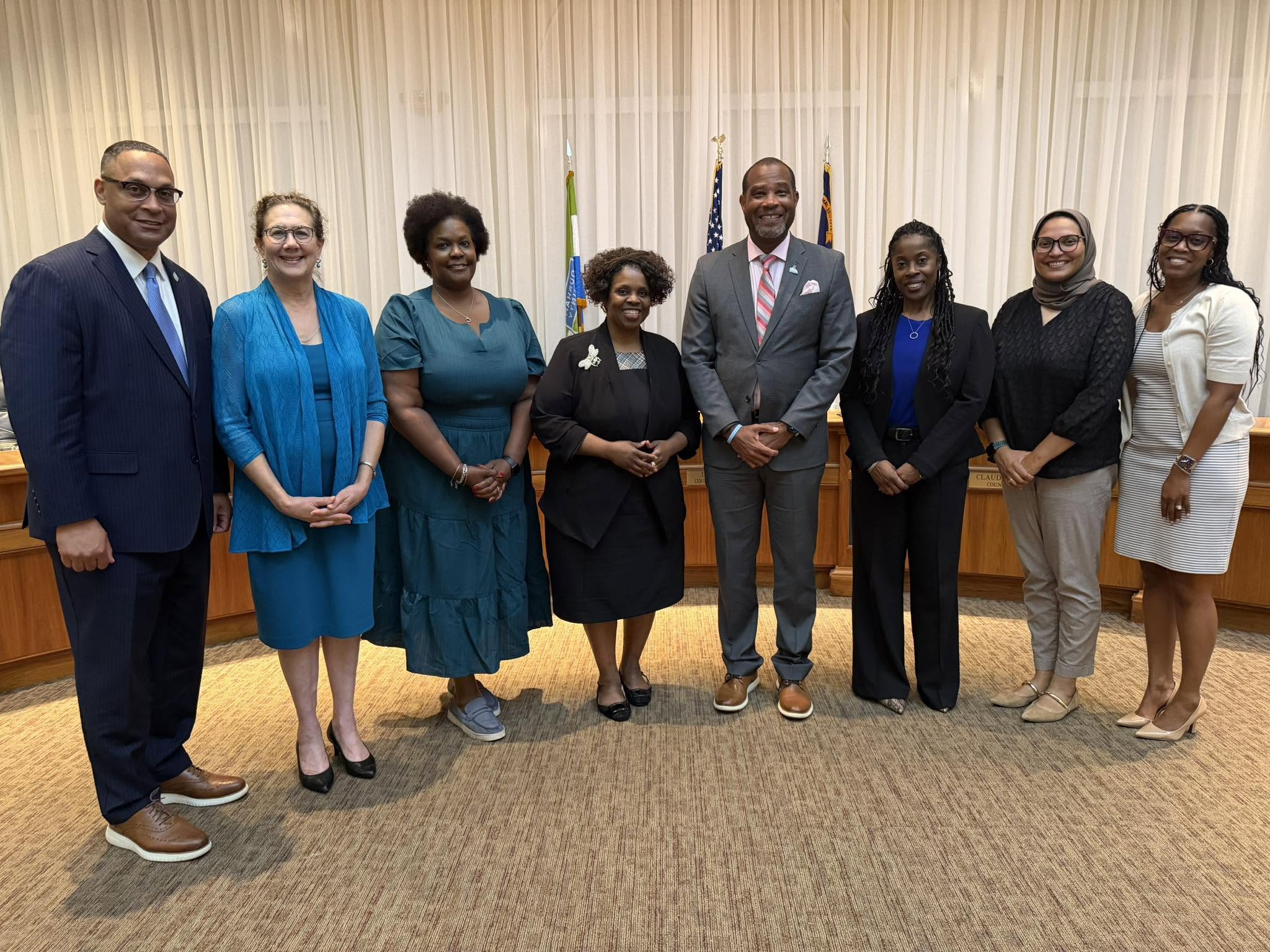 Board of County Commissioners stand with County Manager and County Attorney after passing 2026-2027 budget ordinance