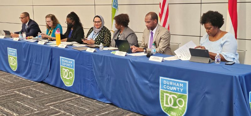 The Board of County Commissioners sit at table during Regular Session in Human Service Building on July 28.