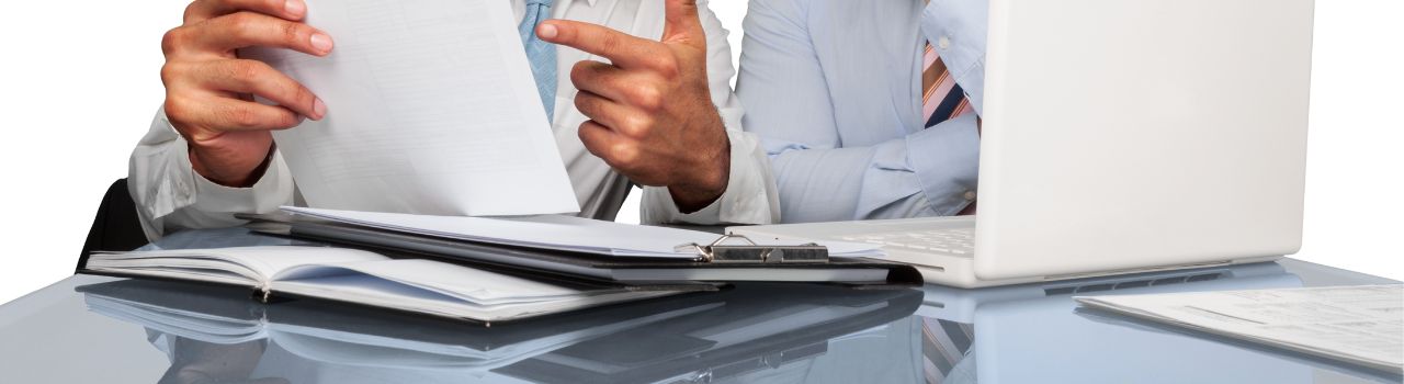 Two men reviewing business documents