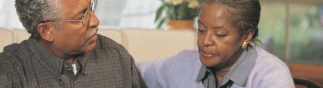 Older couple looking pensive.