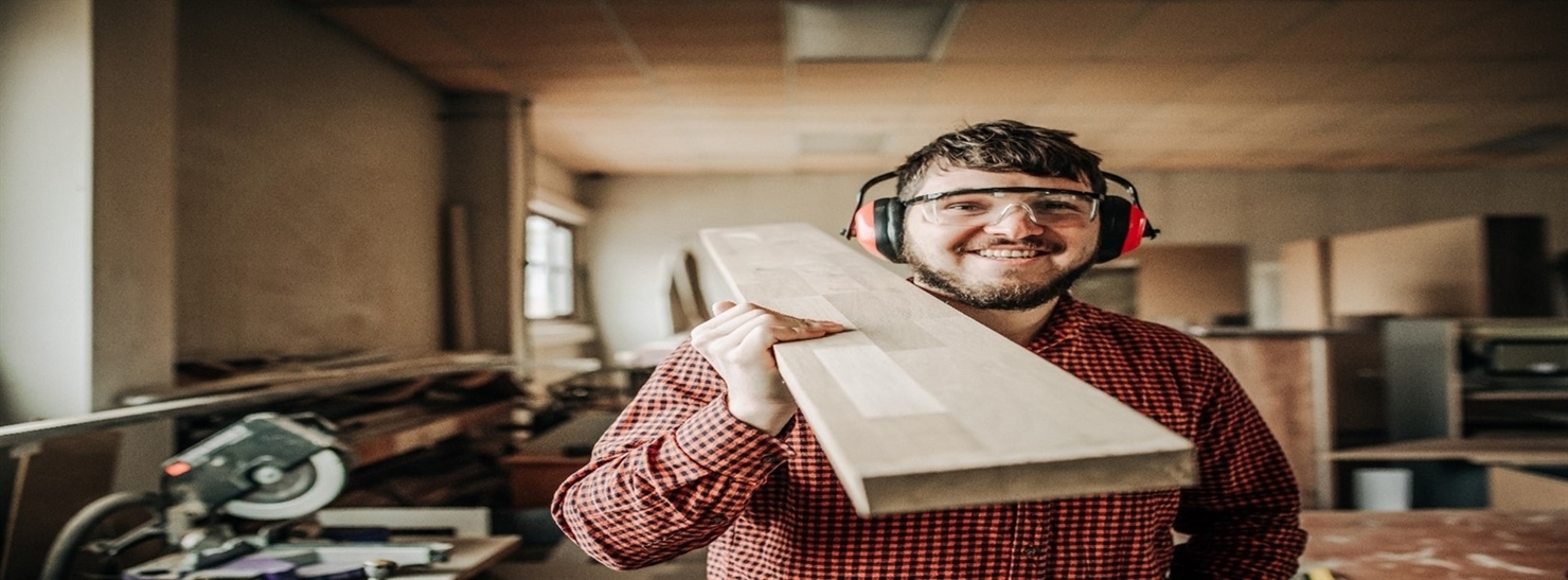 Builder holding a wooden board