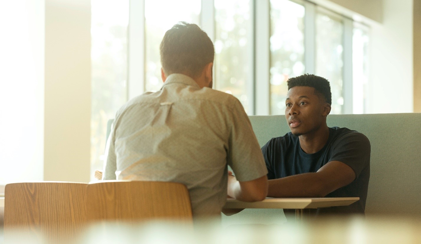 adult with teen at table
